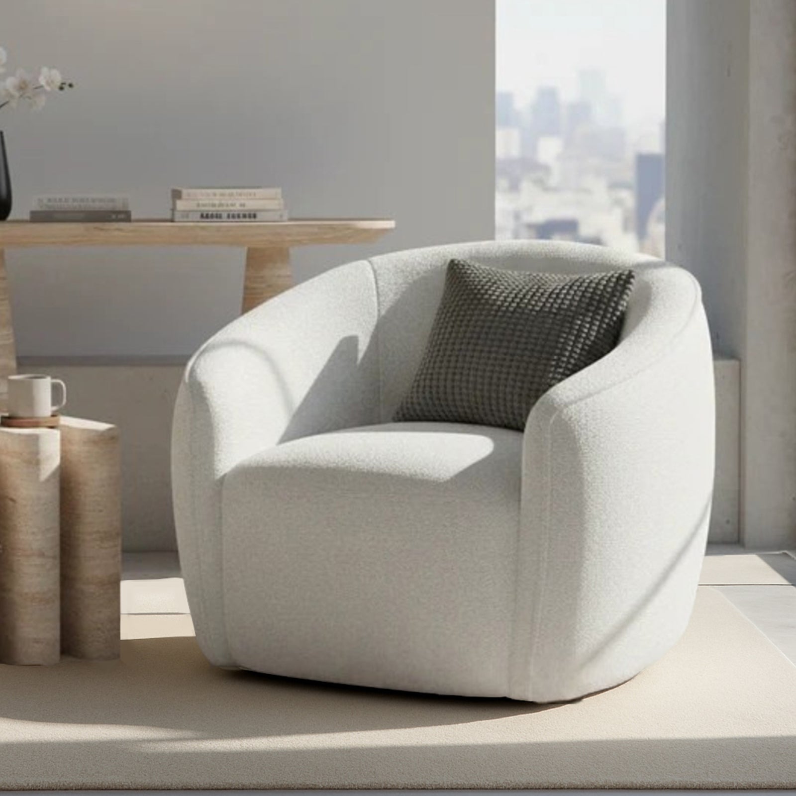Yara Bouclé Accent Chair in Cream White, featuring softly rounded design, light-neutral upholstery, and a textured throw pillow, set on a matching rug beside a sculptural side table with a mug.