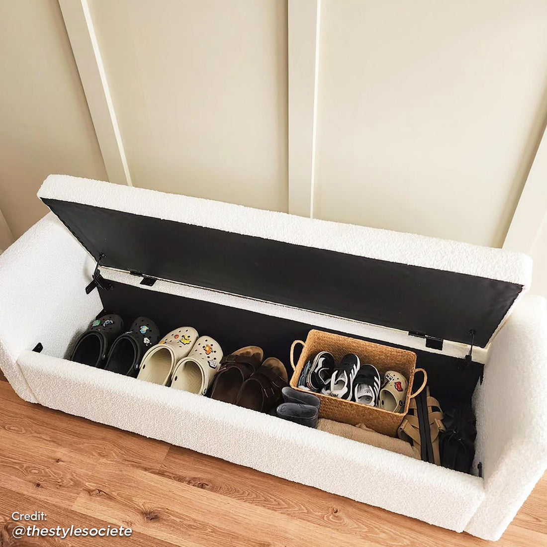 Zamira Large Boucle Storage Ottoman Bench in Cream White, featuring an open lid revealing organized shoe cubby with slip-on shoes, brown sandals, children's sneakers in a basket, and ankle boots.