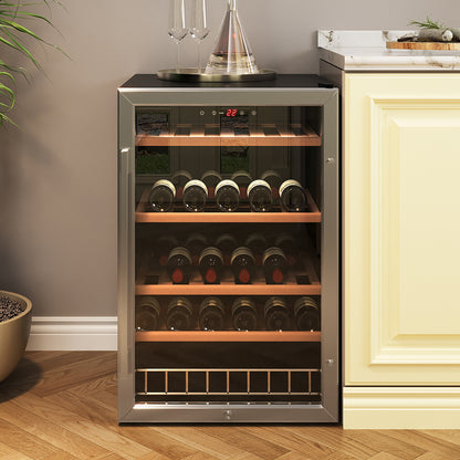 C130 45 Bottle Under Bench Wine Fridge in Black with glass-front door, digital display at 22°C, showcasing four wooden shelves of wine bottles, topped with tray holding glasses and decanter.