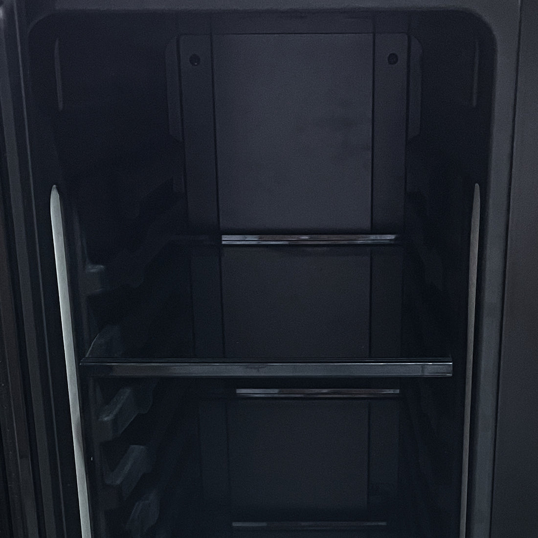 Interior of the H140D 140L Dual Zone Wine Fridge with Chiller in Black, showing the empty compartment with side rails and support bars, ready for wine and drink storage.