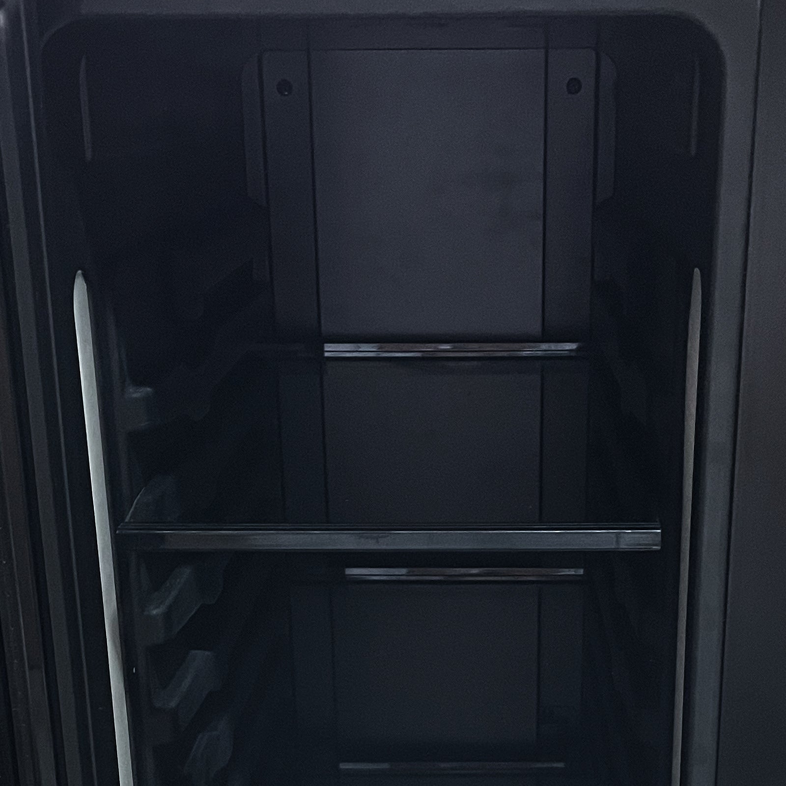 Interior of the H140D 140L Dual Zone Wine Fridge with Chiller in Black, showing the empty compartment with side rails and support bars, ready for wine and drink storage.