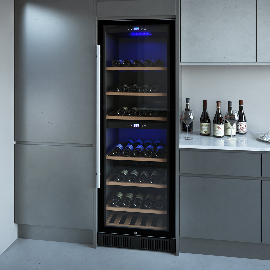VinoVault 180 Bottle Dual Zone Built-In Wine Fridge – Stainless, set in gray cabinetry, displays wine bottles on wooden shelves, with a digital readout and blue lighting, enhancing kitchen elegance.