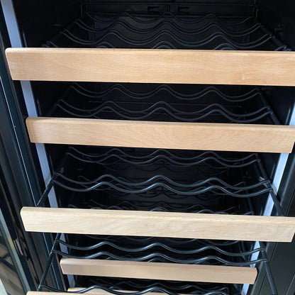 Inside the I122D 365L Dual Zone Wine & Drink Bar Fridge in Black, featuring empty light-wood fronted sliding shelves and black metal supports, ideal for storing wine bottles and beverages.