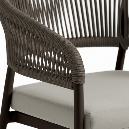 Close-up of Coastal Outdoor Rope Dining Chairs Set of 2 in Brown, showcasing the sleek tubular frame wrapped in dark woven rope and light upholstered seat cushion, highlighting modern coastal design and comfort.