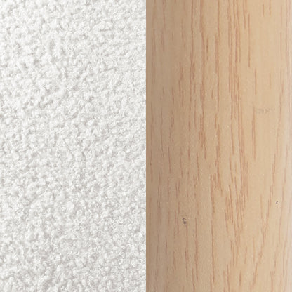 Close-up of white textured fabric next to a light wood surface