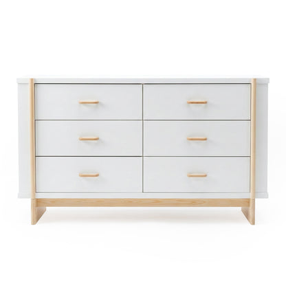 Minimalist six-drawer dresser with white finish and light wood accents on a white background