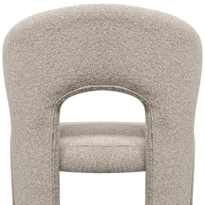 Lunari Bouclé Curved Accent Chair in Beige features a plush, sculpted backrest with a keyhole cutout, padded legs, and a minimalist design, offering comfort and style for modern spaces.