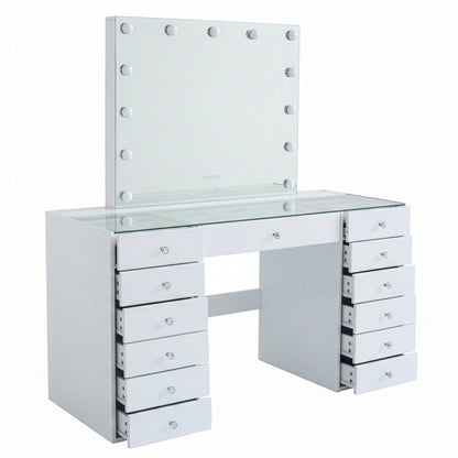 White vanity table with partially open drawers and illuminated mirror on white background