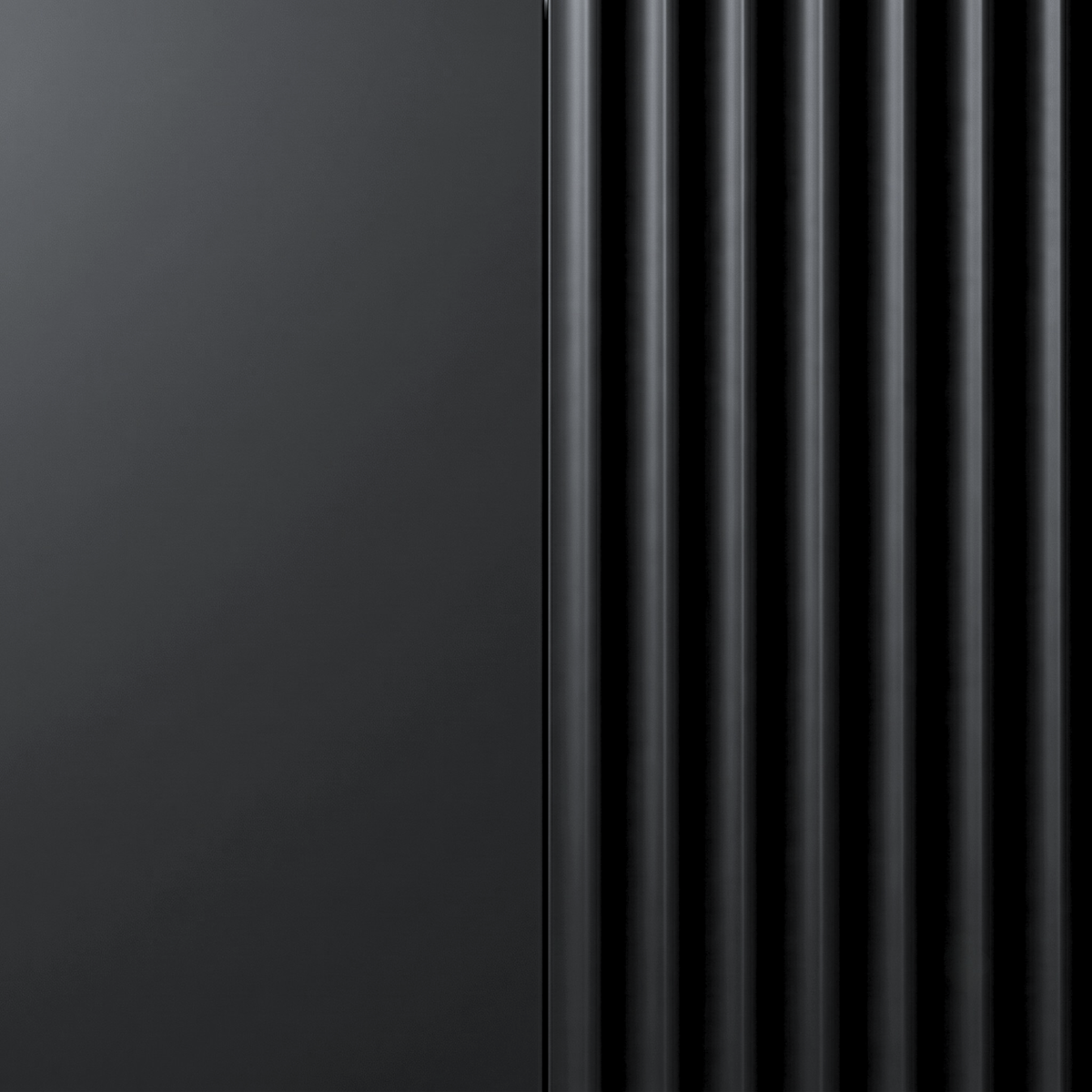 Close-up of a black product surface with smooth and ribbed textures.