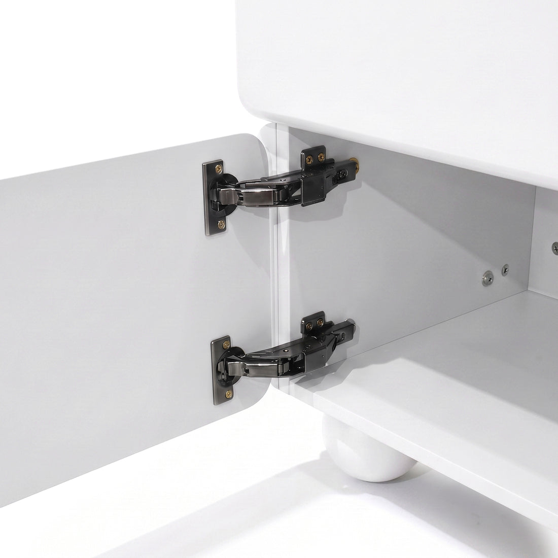 Close-up of cabinet interior with concealed hinges on a white furniture piece