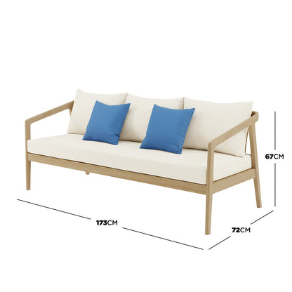 Delva 4 Seater Hardwood Acacia Outdoor Sofa Set in Cream, featuring a light wood frame and cream upholstery with blue throw pillows, showcases a modern design with dimensions 173x72x67 cm.