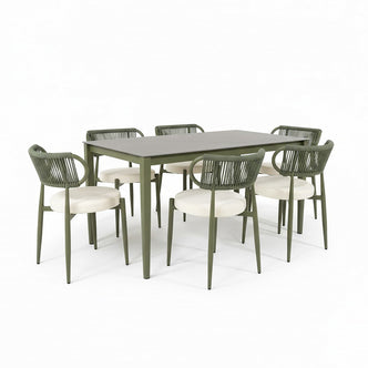 Cabria 7 Piece Sintered Stone Outdoor Dining Set in Green features a grey table with slim metal legs, surrounded by six chairs with woven rope backrests and upholstered seats.