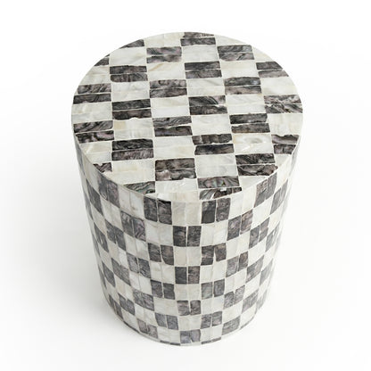 Black and white checkered cylindrical side table on white background