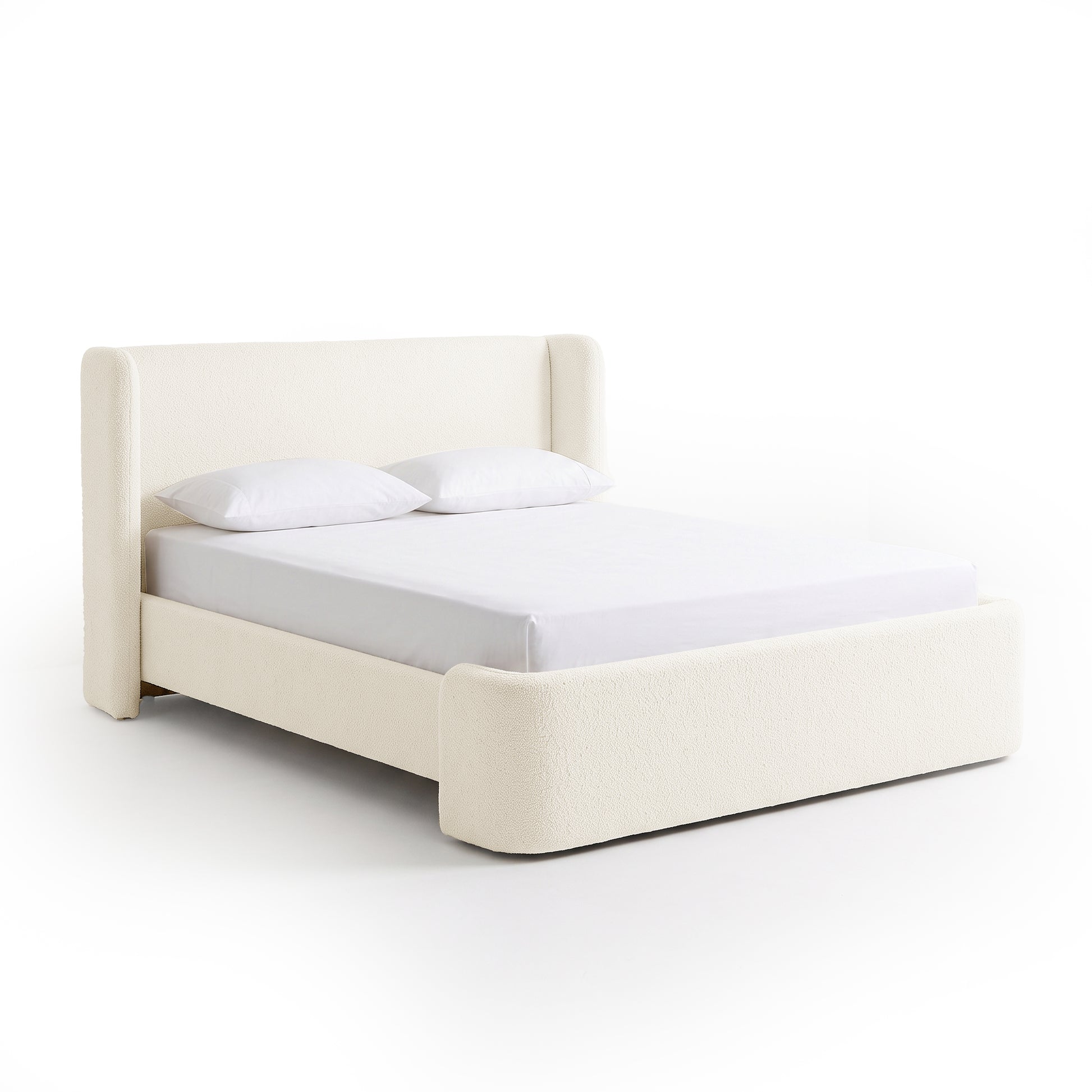 Full upholstered bed on white background, straight-on view