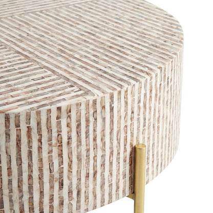 Close-up of striped table surface in earth tones and partial brass leg on white background