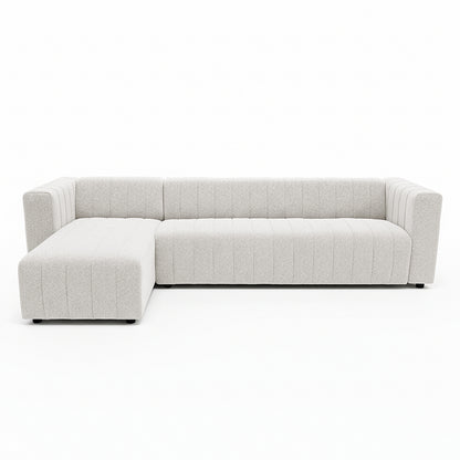 Parisa 4 Seater Tufted Boucle Sofa with Chaise in Cream White, featuring a modern L-shape, channel tufting, and low feet, offers a spacious chaise for lounging in style.