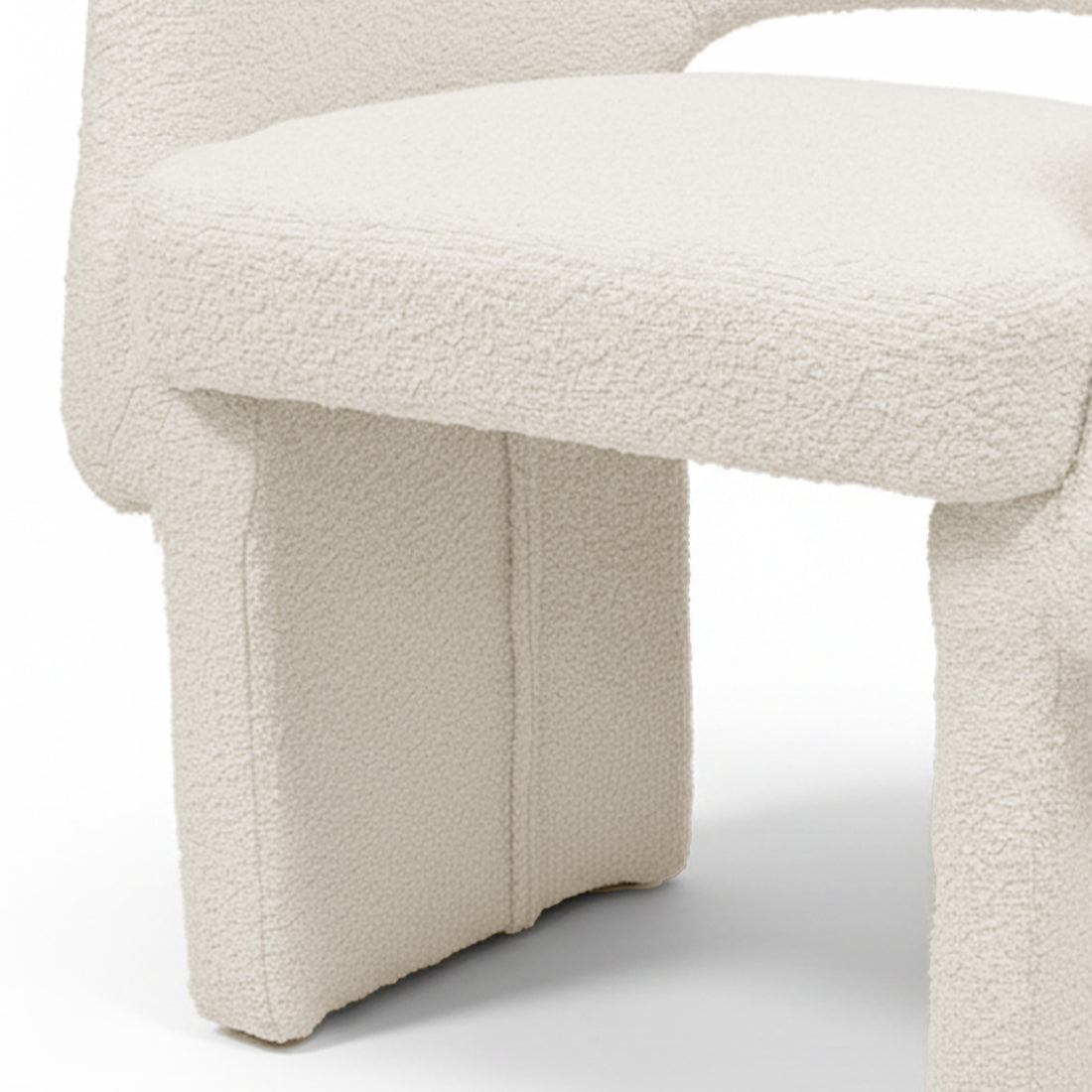 Avela Bouclé Fabric Curved Accent Armchair in Cream White showcasing its plush, cream bouclé upholstery and distinctive chunky, portal-style legs, highlighting modern design and comfort in a compact form.