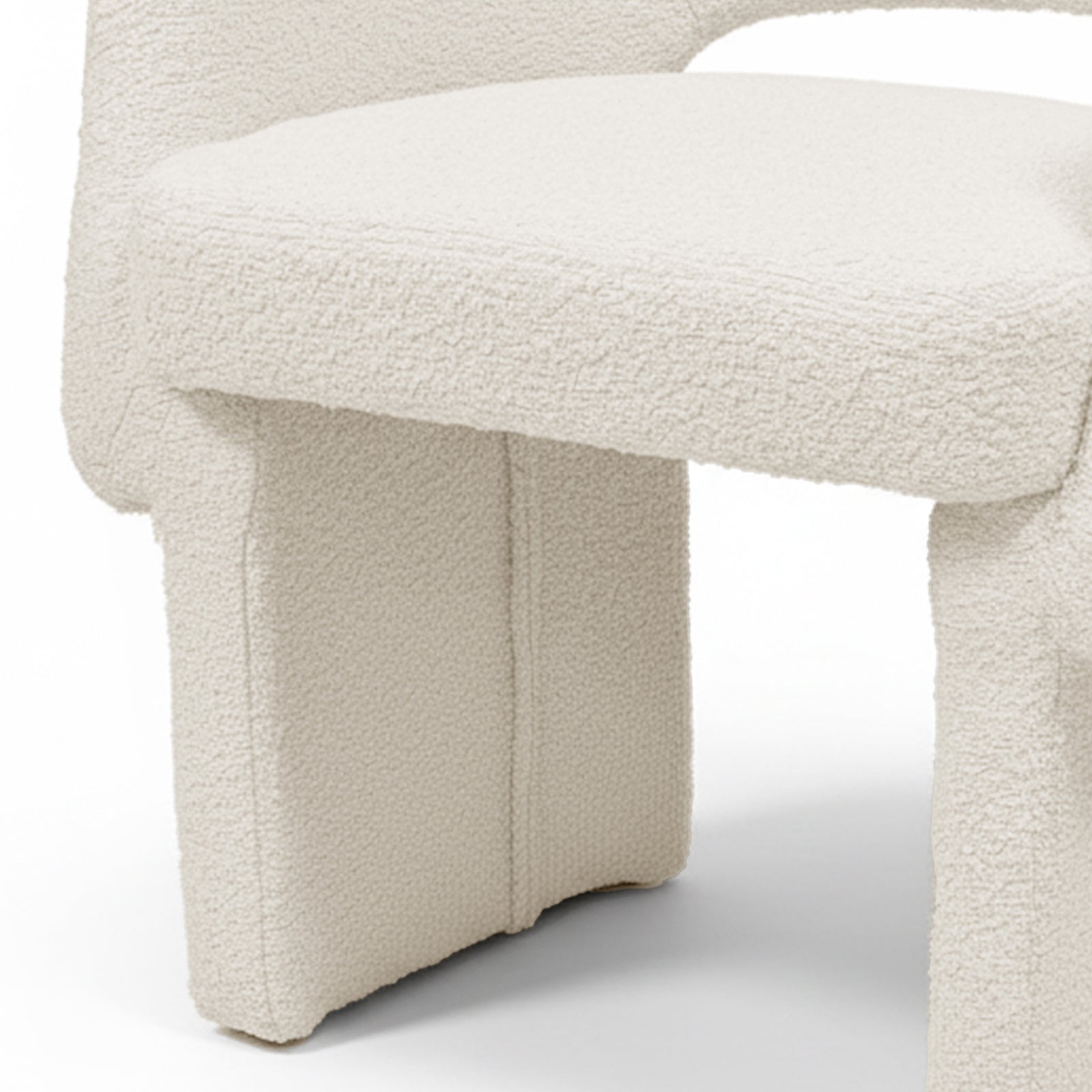 Avela Bouclé Fabric Curved Accent Armchair in Cream White showcasing its plush, cream bouclé upholstery and distinctive chunky, portal-style legs, highlighting modern design and comfort in a compact form.