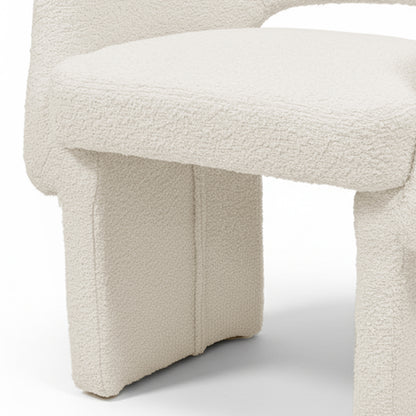 Avela Bouclé Fabric Curved Accent Armchair in Cream White showcasing its plush, cream bouclé upholstery and distinctive chunky, portal-style legs, highlighting modern design and comfort in a compact form.