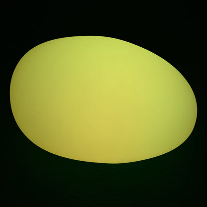 Solar Charging Outdoor LED Rock Light Waterproof Stone Lamp features a softly glowing yellow-green oval form with smooth, slightly irregular edges against a dark background, resembling a natural stone.