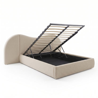 Beige upholstered storage bed with open under-bed compartment on white background