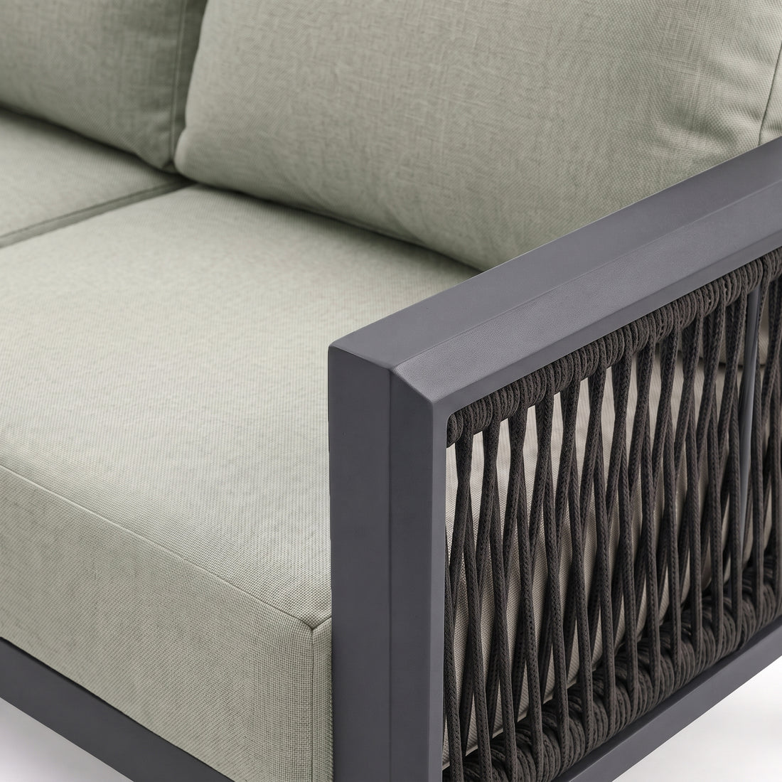 Close-up of sectional armrest and cushions on white background