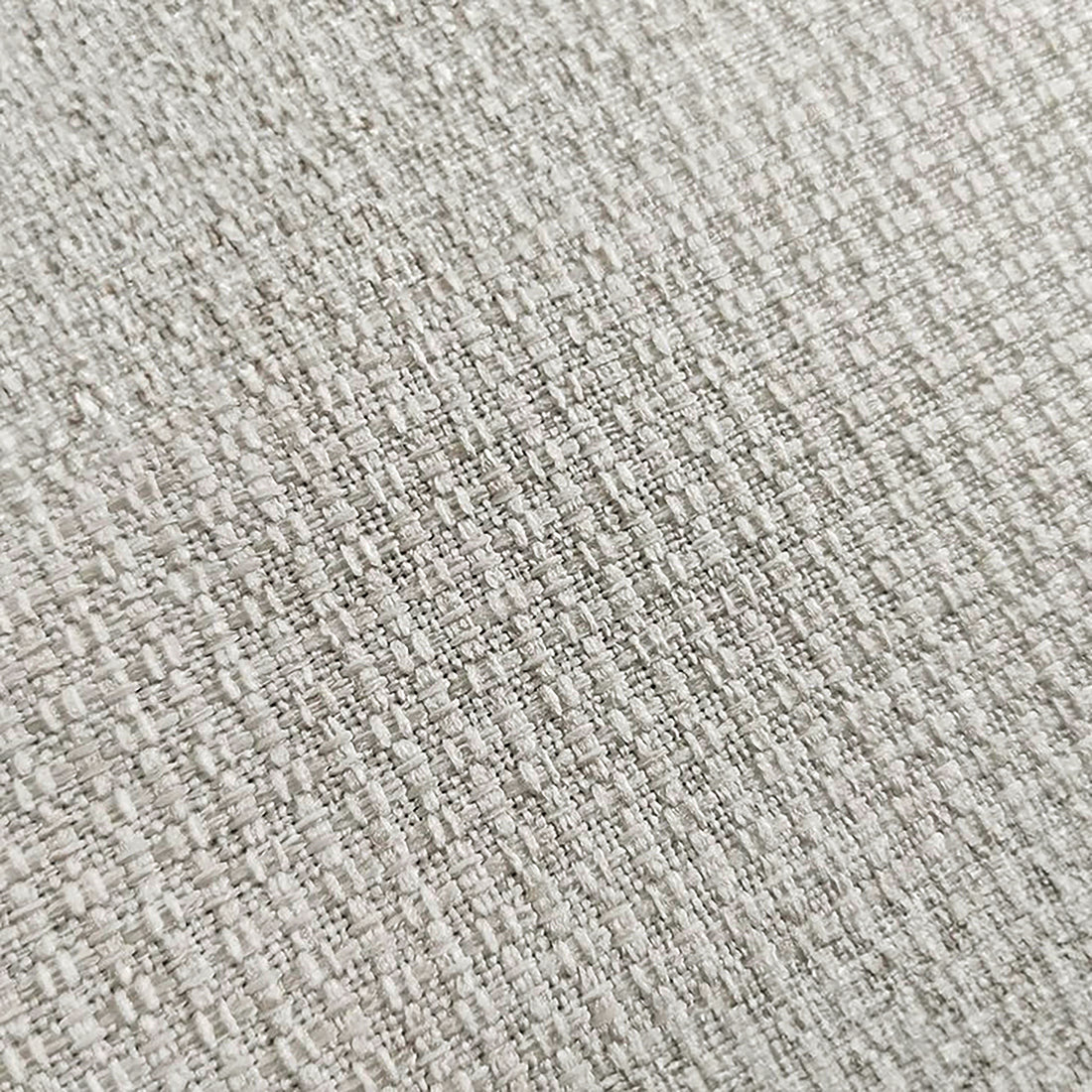 Close-up of light woven upholstery fabric texture.
