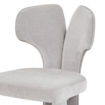 Close-up of the upper backrest and seat of a light gray chair on white background