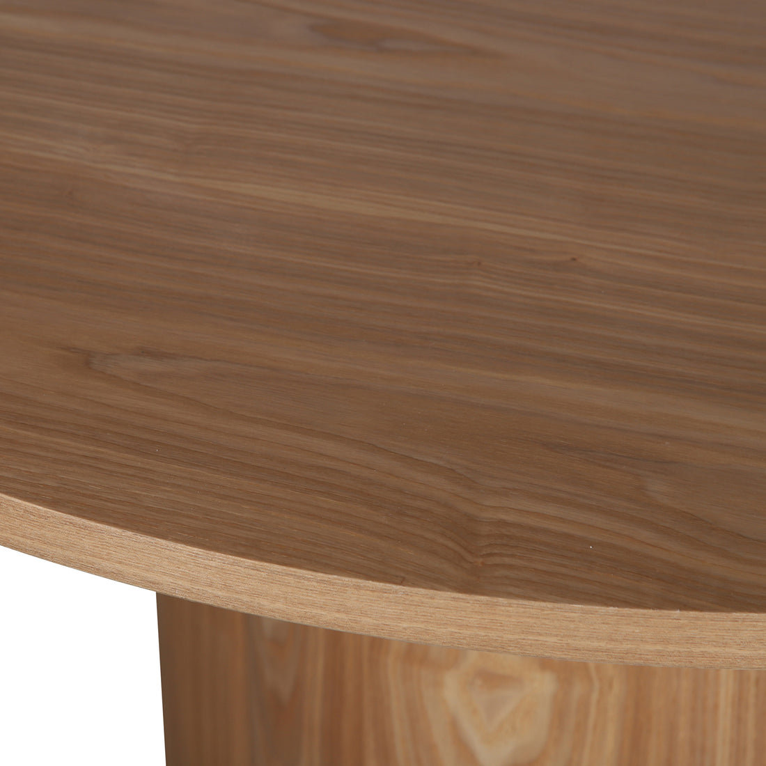 Close-up of the Cece 120cm Round Wooden Dining Table in Oak, showcasing the wood grain and the sturdy pedestal base beneath, highlighting its premium oak veneer finish and modern simplicity.