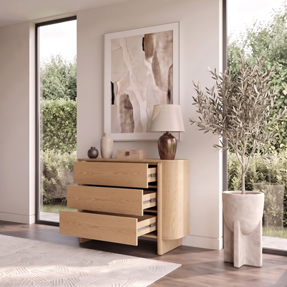 Wooden dresser in a bright room with decor and windows