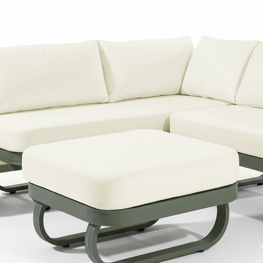 Paloma Modular Outdoor Lounge Set in Olive Green features a cream-cushioned ottoman on a sleek dark green metal frame, coordinating with a matching sectional sofa in the background.