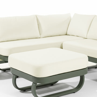 Paloma Modular Outdoor Lounge Set in Olive Green features a cream-cushioned ottoman on a sleek dark green metal frame, coordinating with a matching sectional sofa in the background.