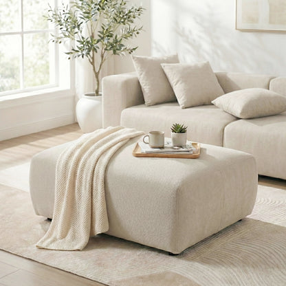Beige ottoman with throw and tray in a modern living room