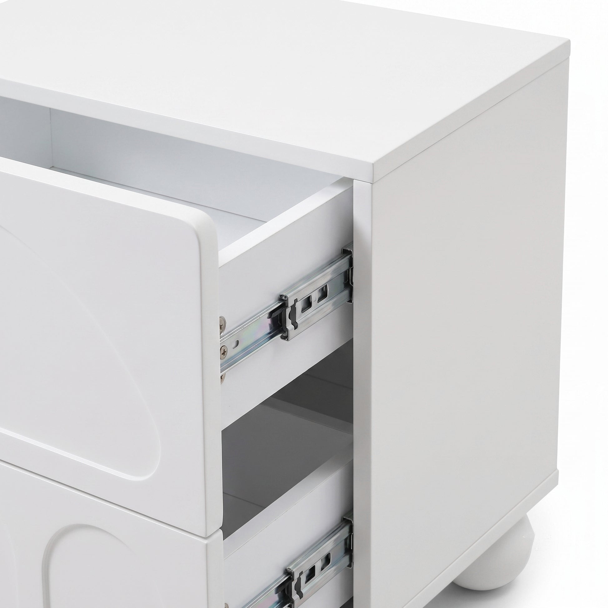 Partial view of a white modern nightstand showing the front and side with one drawer open.