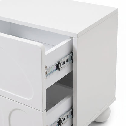 Partial view of a white modern nightstand showing the front and side with one drawer open.