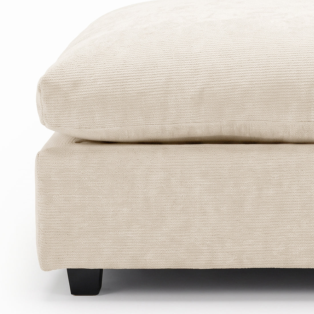 Close-up of beige upholstered furniture corner on a white background