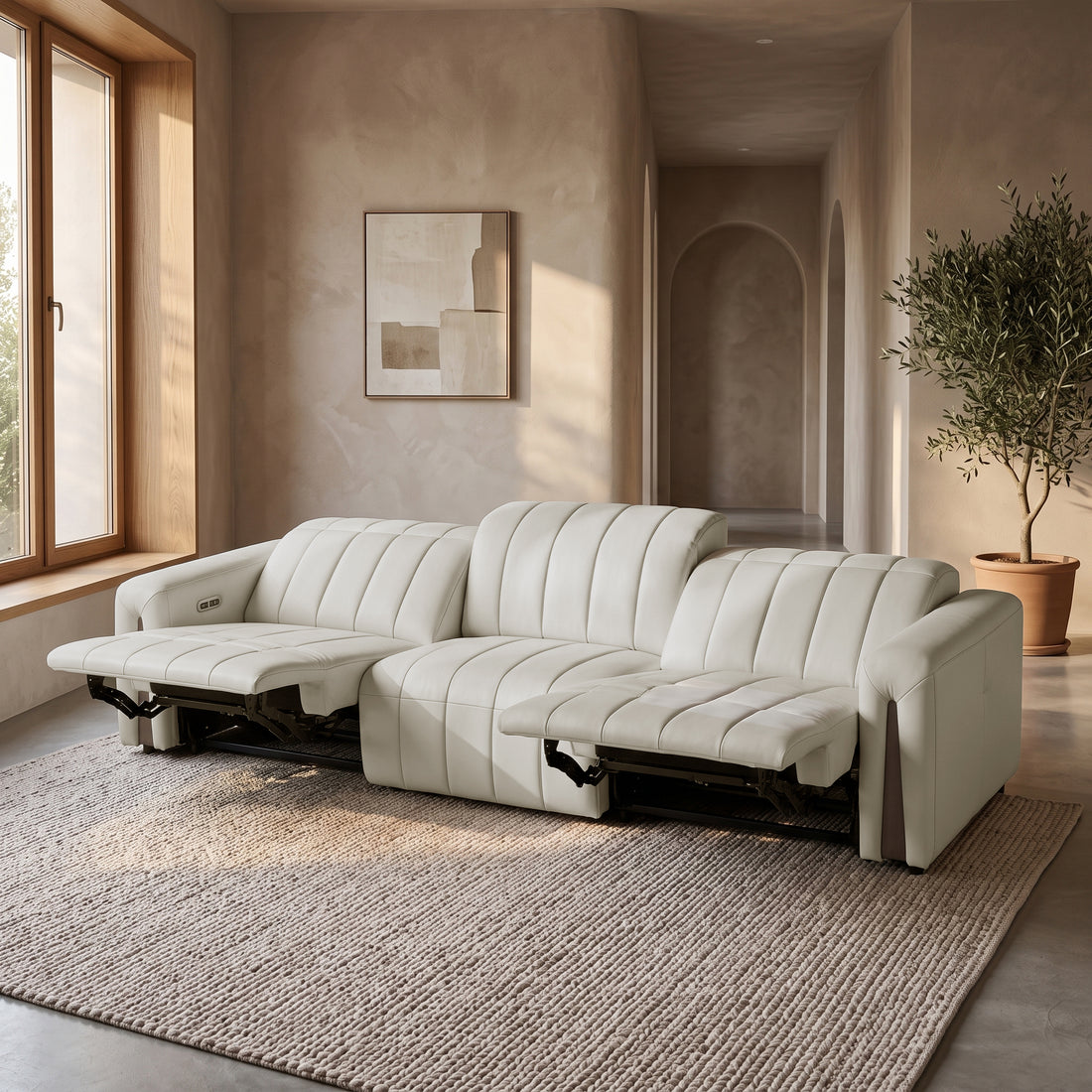 Modern beige reclining sofa in a styled living room.