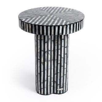 Black and white striped cylindrical side table on white background