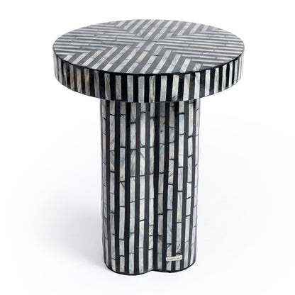 Black and white striped cylindrical side table on white background