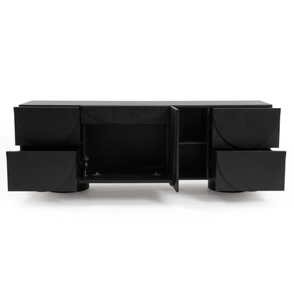 Black timber sideboard with open drawers and doors displaying carved semi-circle patterns against a plain white studio background