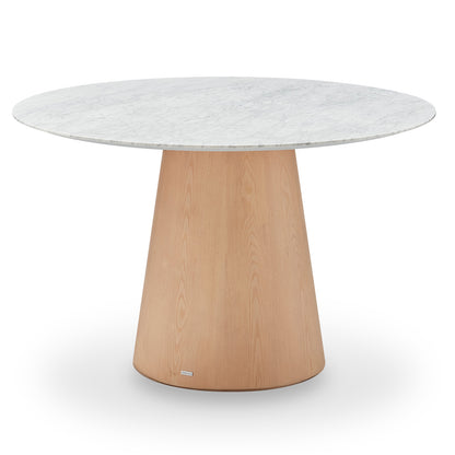 Dina 120cm Round Marble Dining Table in Carrara Natural with a white marble-look tabletop and a tapered light-wood pedestal base, designed for elegance and stability, enhancing dining spaces with luxury.