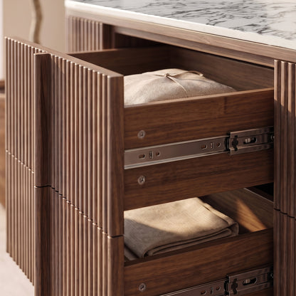 Close-up of open drawers with folded linens in a styled interior