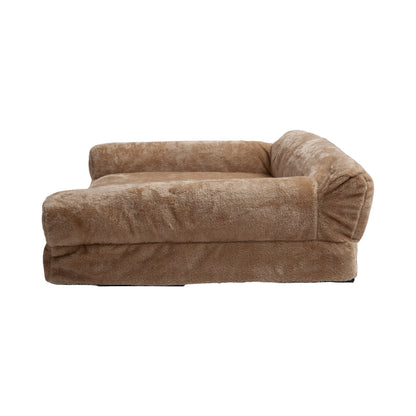 Side view of plush tan dog bed on white background