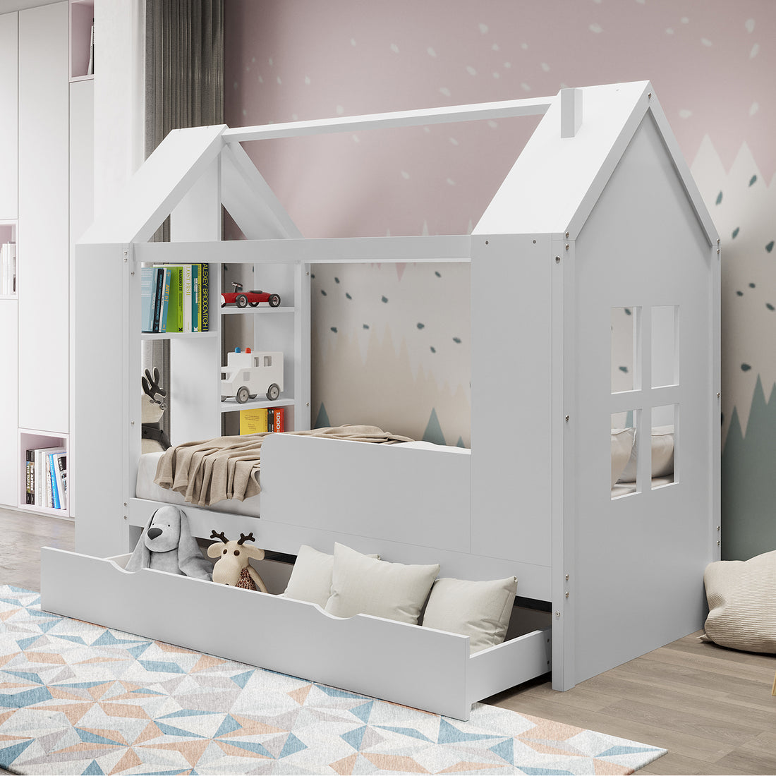 Haron Single Cubby House Bed Storage in White features a house-shaped frame, built-in shelves with toy vehicles, a large underbed drawer with plush toys, and a geometric rug underneath.