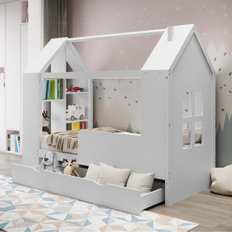 Haron Single Cubby House Bed Storage in White features a house-shaped frame, built-in shelves with toy vehicles, a large underbed drawer with plush toys, and a geometric rug underneath.