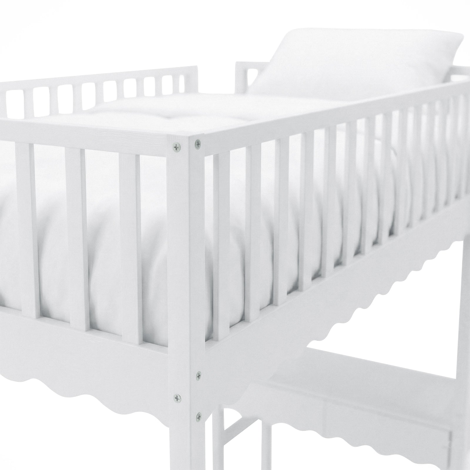 Partial view of white crib on white background