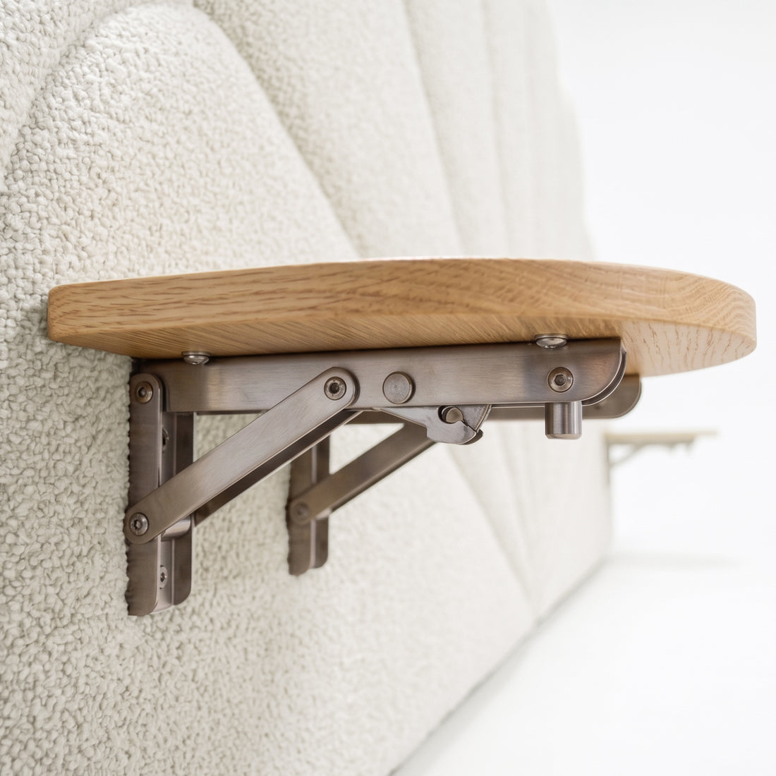 Close-up of wooden shelf with metal brackets in interior setting