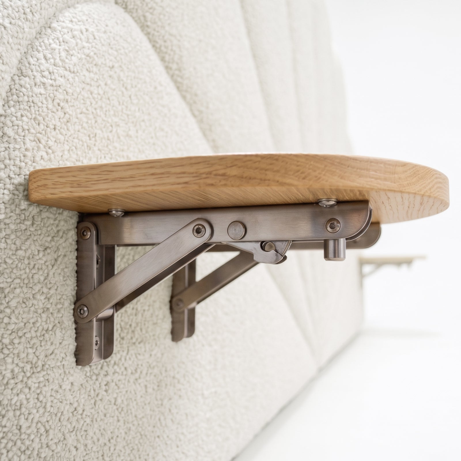 Close-up of wooden shelf with metal brackets in interior setting