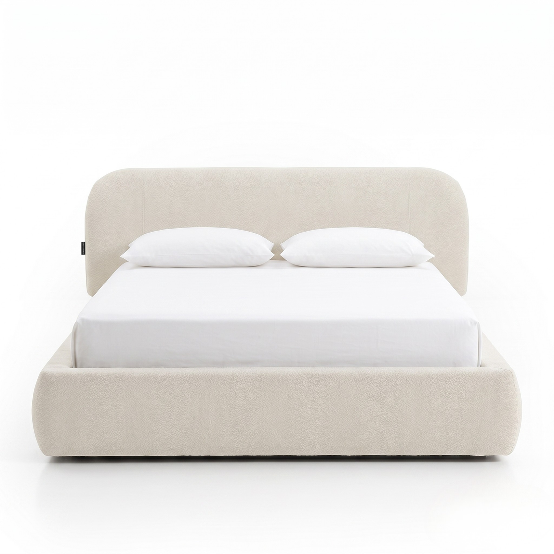 Modern upholstered bed with pillows shown fully on a white background