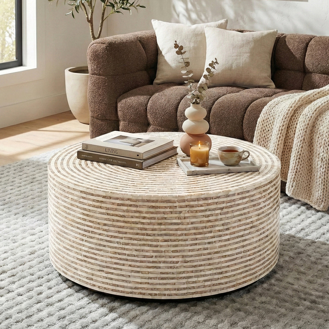 Round mosaic coffee table in a living room with sofa and decor
